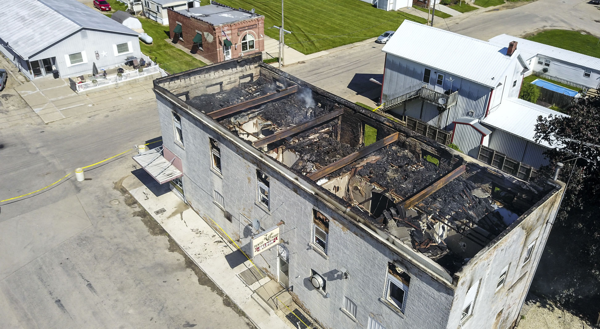 Fire still smolders after the building that housed the Painted Horse Saloon and second-floor apartments at 268 Jess St. in Bernard, Iowa caught fire in the early morning hours Wednesday, May 26, 2021. PHOTO CREDIT: Dave Kettering