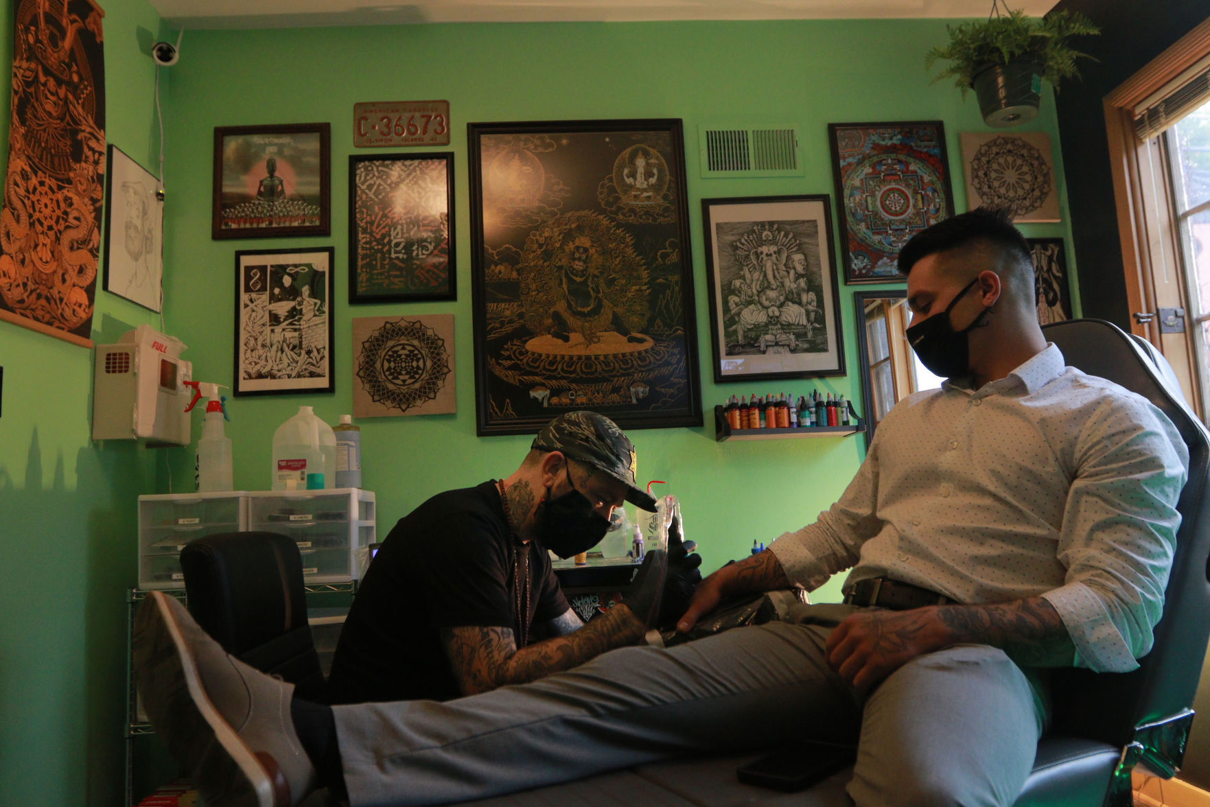 Ben Johnson, co-owner of Emerald Buddha Tattoo, gives a tattoo to Stephen Grisez, of Plattville, Wis., at the Galena, Ill., tattoo shop on Thursday, May 27, 2021.    PHOTO CREDIT: Katie Goodale