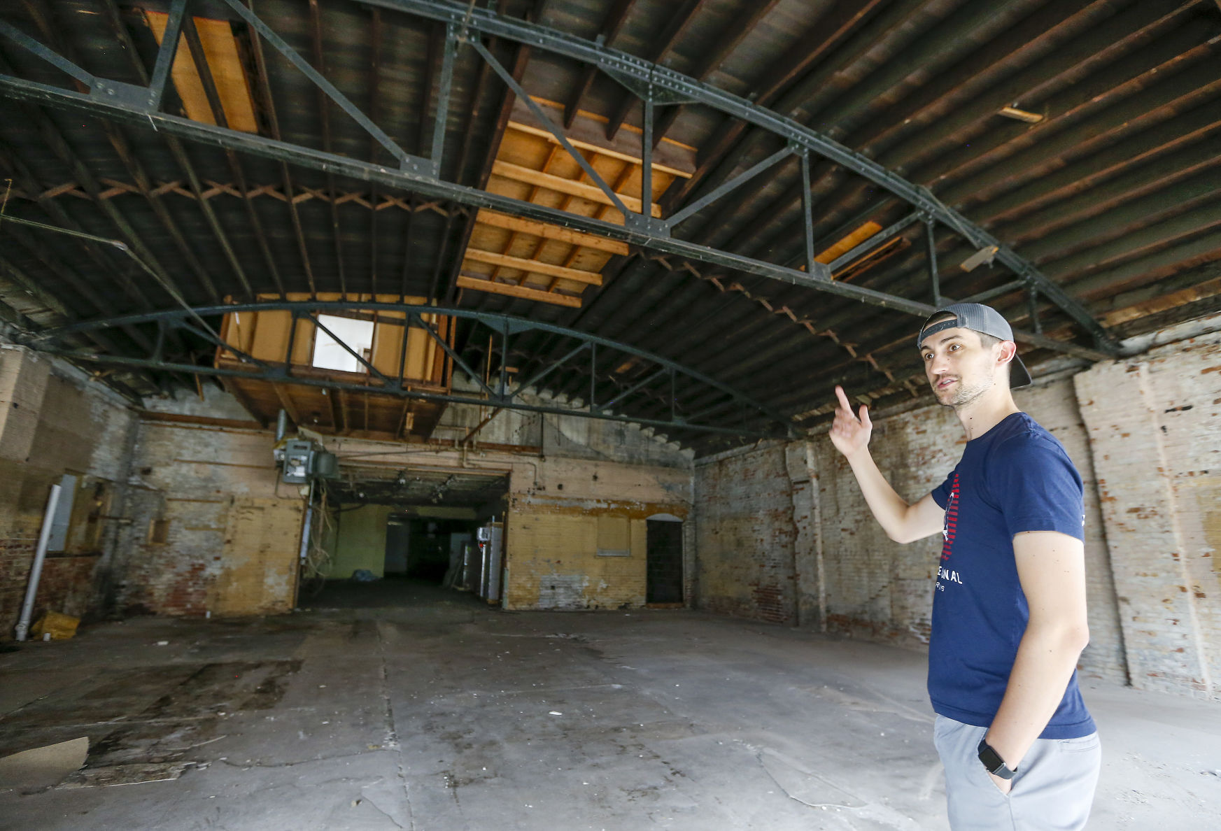 Bart Frederick, taproom manager for Dimensional Brewing Co. in Dubuque, shows the adjacent building at 99 Main St. that the brewery recently acquired. The space formerly housed Fido Fit and will be converted into additional taproom space and event center. PHOTO CREDIT: Dave Kettering