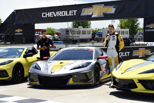 Drivers Jordan Taylor (left) and Tommy Milner attend a news conference while standing next to a Corvette C8.R race car at Raceway at Belle Isle in Detroit.  PHOTO CREDIT: Jose Juarez