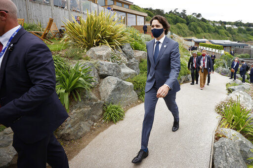 Canadian Prime Minister Justin Trudeau, center, arrives for the G7 meeting at the Carbis Bay Hotel in Carbis Bay, St. Ives, Cornwall, England, Friday, June 11, 2021. Leaders of the G7 begin their first of three days of meetings on Friday, in which they will discuss COVID-19, climate, foreign policy and the economy. (Phil Noble, Pool via AP) PHOTO CREDIT: Phil Noble