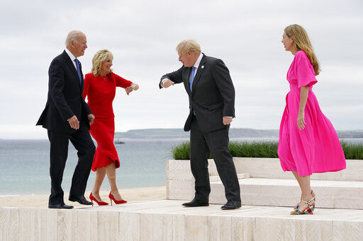 President Joe Biden and first lady Jill Biden are greeted by British Prime Minister Boris Johnson and his wife Carrie Johnson before posing for photos at the G-7 summit, Friday, June 11, 2021, in Carbis Bay, England. (AP Photo/Patrick Semansky, Pool) PHOTO CREDIT: Patrick Semansky