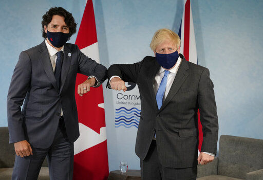 British Prime Minister Boris Johnson, right, greets Canadian Prime Minister Justin Trudeau with an elbow bump prior to a bilateral meeting during the G7 meeting at the Carbis Bay Hotel in Carbis Bay, St. Ives, Cornwall, England, Friday, June 11, 2021. Leaders of the G7 begin their first of three days of meetings on Friday, in which they will discuss COVID-19, climate, foreign policy and the economy. (AP Photo/Alastair Grant, Pool) PHOTO CREDIT: Alastair Grant