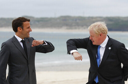 British Prime Minister Boris Johnson, right, greets French President Emmanuel Macron during arrivals for the G7 meeting at the Carbis Bay Hotel in Carbis Bay, St. Ives, Cornwall, England, Friday, June 11, 2021. Leaders of the G7 begin their first of three days of meetings on Friday, in which they will discuss COVID-19, climate, foreign policy and the economy. (Phil Noble, Pool via AP) PHOTO CREDIT: Phil Noble