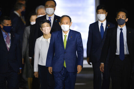 Japanese Prime Minister Yoshihide Suga and his wife Mariko Suga arrive at Newquay Airport in southwest England early Friday June 11, 2021 where he will attend the G7 Summit to be held at Carbis Bay in Cornwall. (Leon Neal/Pool via AP) PHOTO CREDIT: Leon Neal