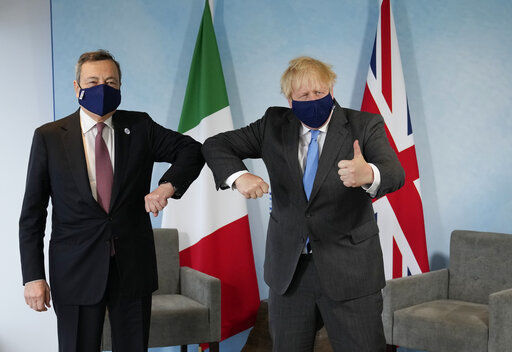 British Prime Minister Boris Johnson, right, gives the thumbs up as he greets Italy