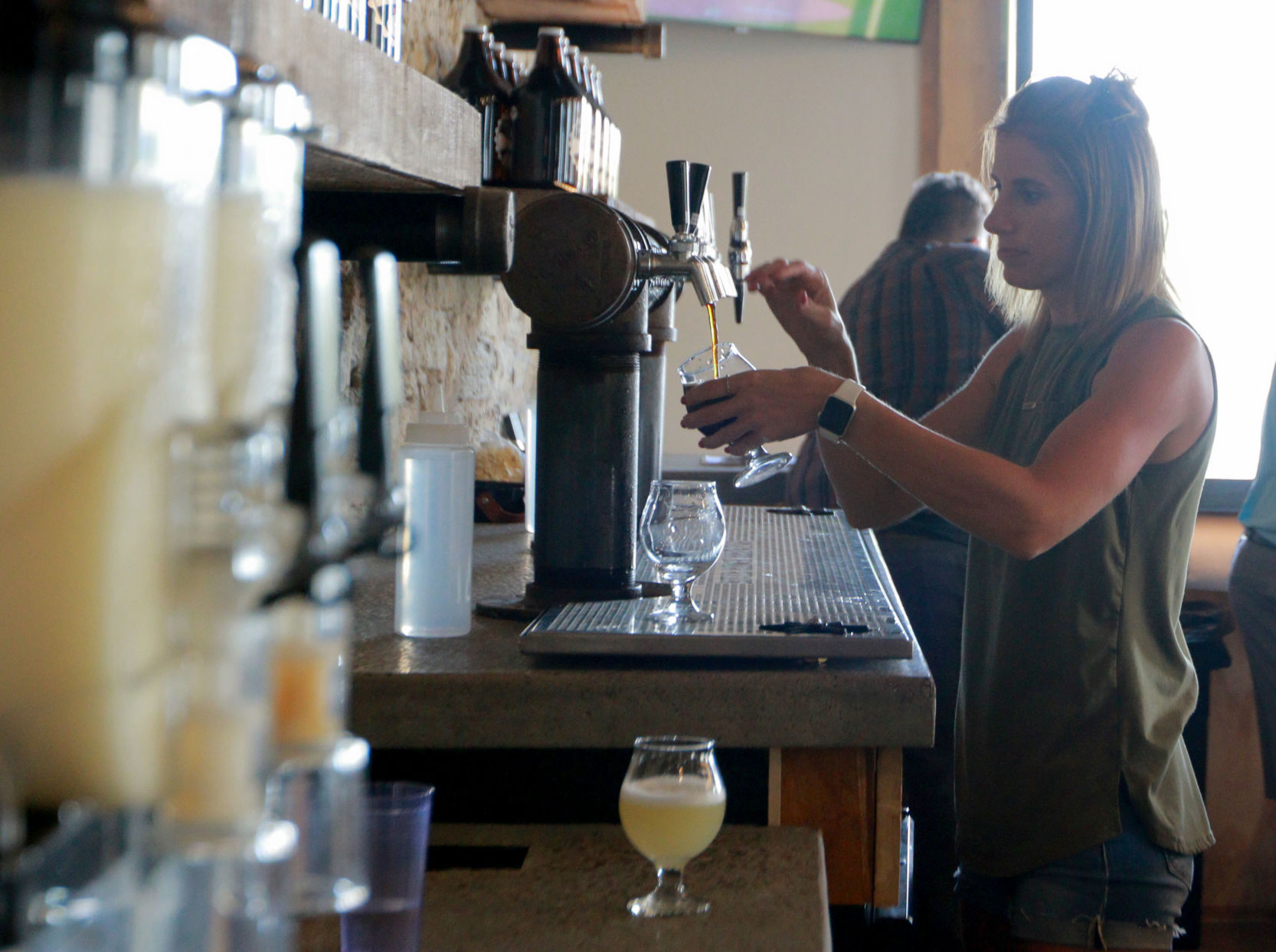 Bartender Abby Veach prepares a drink at River Ridge Brewing in Bellevue, Iowa, on Saturday, June 5, 2021. PHOTO CREDIT: Katie Goodale