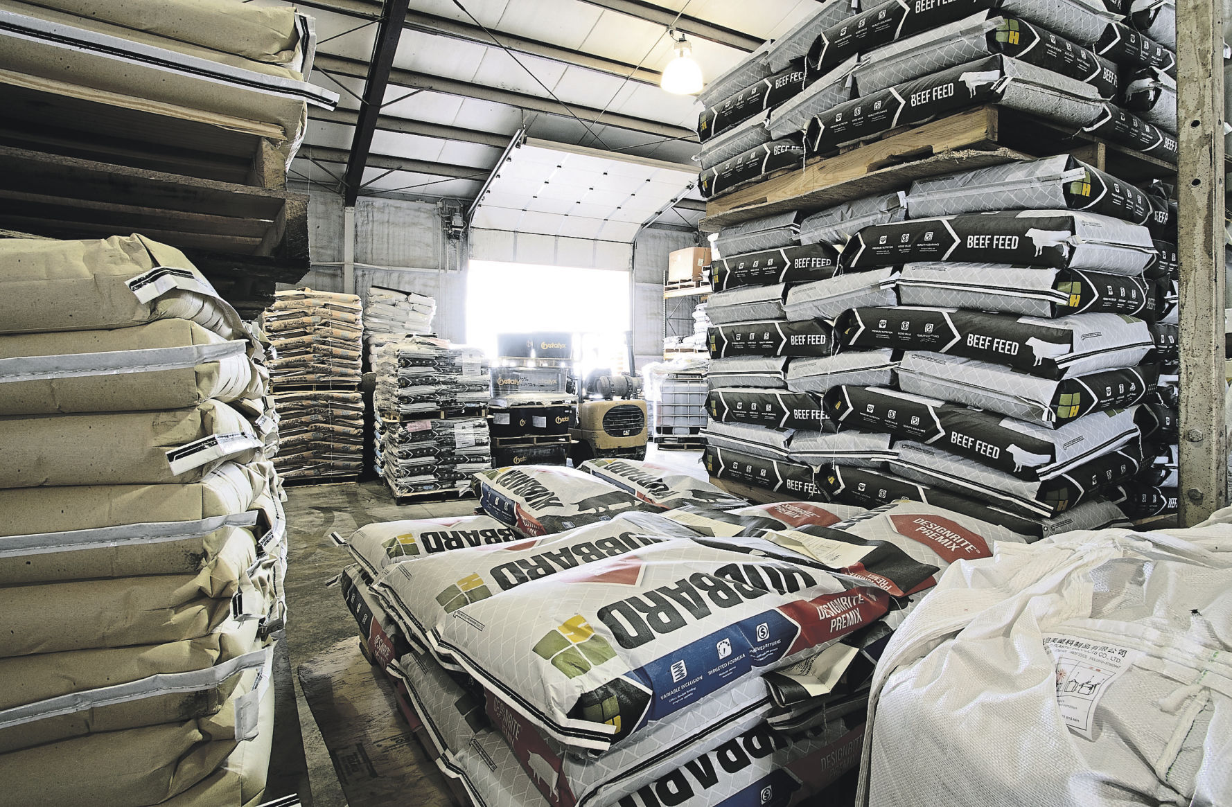 Bags of feed are stacked in the warehouse.    PHOTO CREDIT: Stephen Gassman