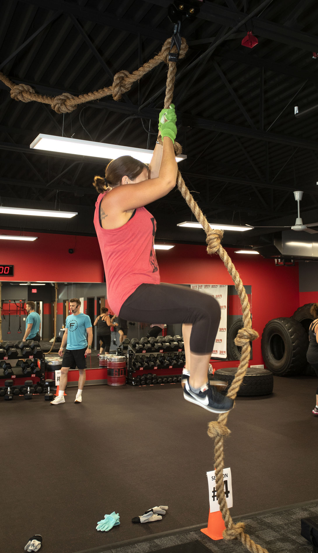 Heather Halverson, of Platteville, climbs a rope as part of her workout at FIRE Fitness in Platteville, Wis., on Monday.    PHOTO CREDIT: Stephen Gassman