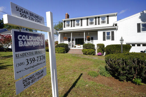 FILE - In this Oct. 6, 2020 file photo, a real estate brokerage sign stands in front of a house in Norwood, Mass. Sales of previously-occupied homes fell for the fourth straight month in May 2021, as soaring prices and a limited number of available properties discouraged many would-be buyers. (AP Photo/Steven Senne, File) PHOTO CREDIT: Steven Senne