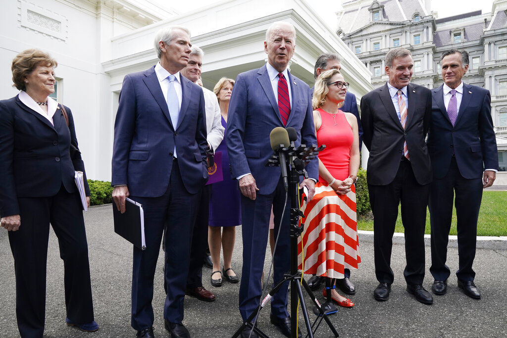 President Joe Biden, with a bipartisan group of senators, speaks today outside the White House in Washington. Biden announced a bipartisan agreement on a $953 billion infrastructure plan that would achieve his top legislative priority and validate his efforts to reach across the political aisle. PHOTO CREDIT: Jacquelyn Martin