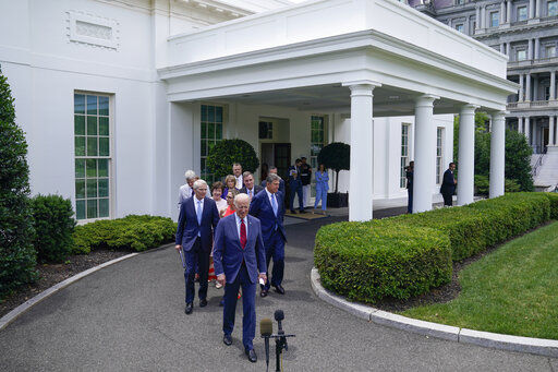 President Joe Biden walks out of the White House with Senators to speak Thursday, June 24, 2021, in Washington. (AP Photo/Evan Vucci) PHOTO CREDIT: Evan Vucci