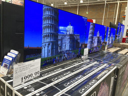 A sign displays the price of a 65-inch television lined up with countless other televisions in a Costco warehouse on Thursday, June 17, 2021, in Loen Tree, Colo. The Commerce Department said Thursday, June 24 that growth in the gross domestic product, the country’s total output of goods and services, was unchanged from two previous estimates.(AP Photo/David Zalubowski) PHOTO CREDIT: David Zalubowski