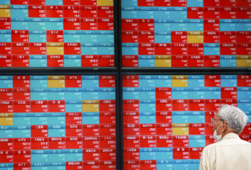 A man looks at an electronic stock board of a securities firm in Tokyo. Stocks are off to a mixed start on Wall Street as the market regroups following the biggest weekly gain for the S&P 500 since February. PHOTO CREDIT: Koji Sasahara