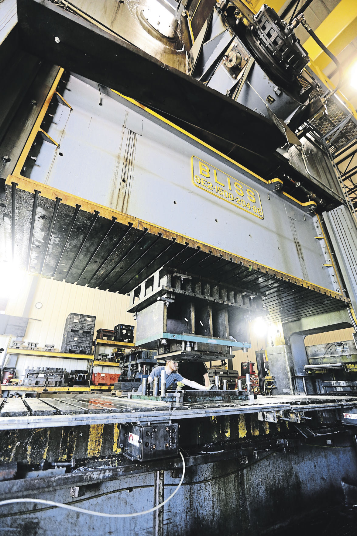 Employees of Uelner Precision Tools & Dies operate the largest press on-site, a 1,500-ton press. The Dubuque business, which creates parts components for numerous manufacturers, will celebrate 75 years in 2021.    PHOTO CREDIT: Dave Kettering