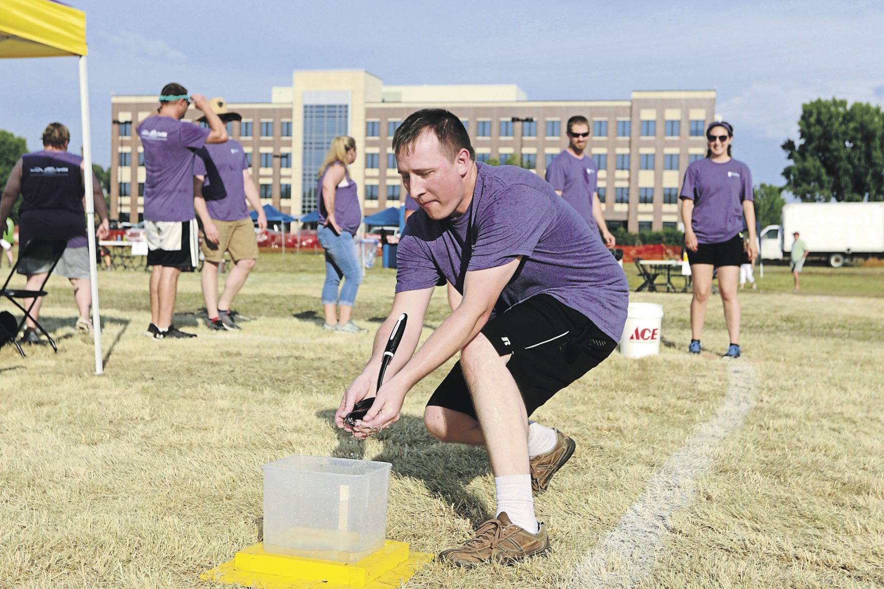 Teams participate in a water game at the Area Residential Care Corporate and Community game night at the Port of Dubuque on Friday, June 11, 2021.    PHOTO CREDIT: Katie Goodale