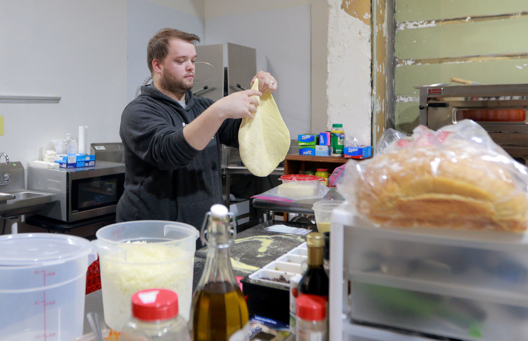 Brooks Duff-Bowers makes pizza at the Other Side at Second Chance Coffee and Music in Shullsburg, Wis., on Friday.    PHOTO CREDIT: Katie Goodale