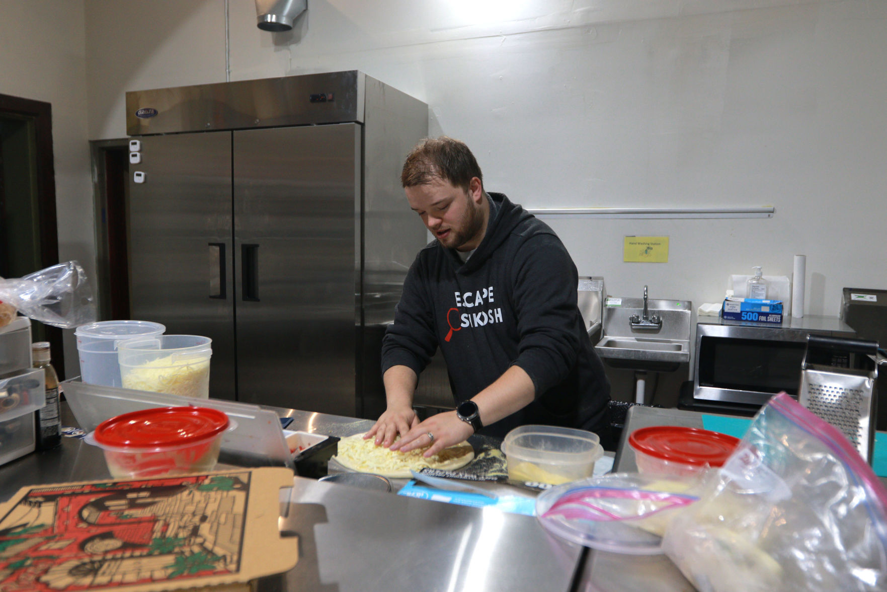 Brooks Duff-Bowers makes a pizza at the Other Side at Second Chance Coffee and Music in Shullsburg, Wis., on Friday.    PHOTO CREDIT: Katie Goodale