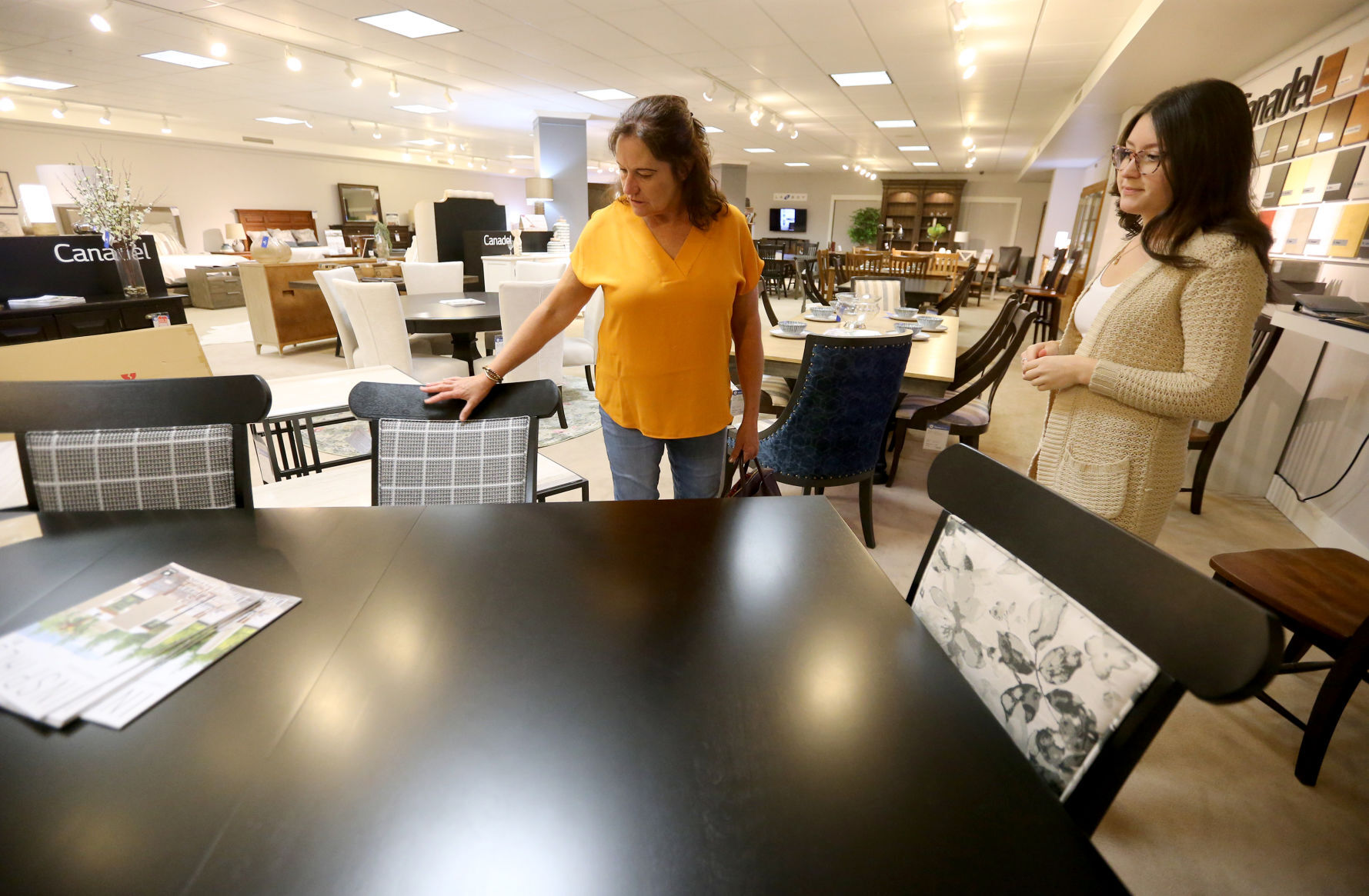 Kassy Jacobs (right) talks with customer Donna Runde, of Platteville, Wis., while looking at furniture at Home+FloorShow in Dubuque on Wednesday, July 14, 2021. PHOTO CREDIT: JESSICA REILLY
