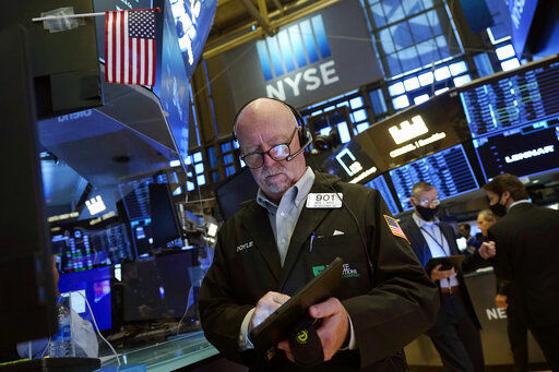Trader John Doyle works on the floor of the New York Stock Exchange on Friday. PHOTO CREDIT: Richard Drew