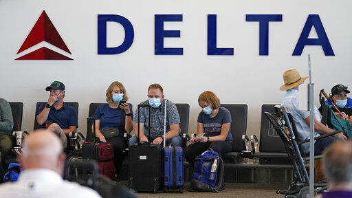 Air travel in the United States hit another pandemic-era record over the weekend as vacationers jammed airports, but shares of airlines, cruise lines, hotels and almost anything else related to travel are tumbling on growing concerns about highly contagious variants of coronavirus.    PHOTO CREDIT: Rick Bowmer