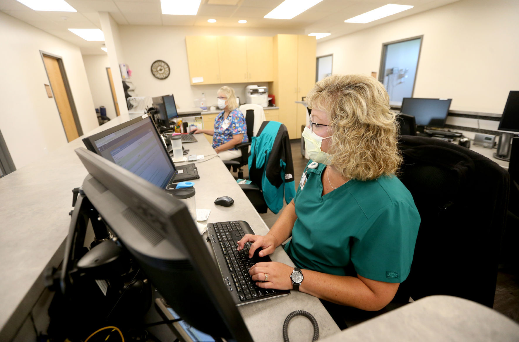 Patti Jackson (left), a certified medical assistant, and Brenda Baltierra, a registered nurse, log notes at FHN Jo Daviess Family Healthcare Center in Stockton, Ill., on Monday.    PHOTO CREDIT: JESSICA REILLY