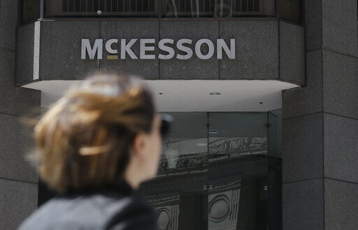 FILE - In this July 17, 2019, file photo, a pedestrian passes a McKesson sign on an office building in San Francisco. The three biggest U.S. drug distribution companies and the drugmaker Johnson & Johnson are on the verge of a $26 billion settlement covering thousands of lawsuits over the toll of opioids across the U.S., two people with knowledge of the plans told The Associated Press. The settlement involving McKesson, AmerisourceBergen and Cardinal Health is expected this week. A $1 billion-plus deal involving the three distributors and the state of New York was planned for Tuesday, July 20, 2021. (AP Photo/Jeff Chiu, File)    PHOTO CREDIT: Jeff Chiu