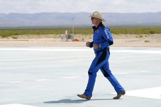 Jeff Bezos, founder of Amazon and space tourism company Blue Origin jogs onto the Blue Origin