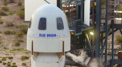 The passengers of the Blue Origin enter the capsule near Van Horn, Texas, Tuesday, July 20, 2021. The rocket is scheduled to launch later this morning will carry passengers Jeff Bezos, founder of Amazon and space tourism company Blue Origin, brother Mark Bezos, Oliver Daemen and Wally Funk. (Blue Origin via AP) PHOTO CREDIT: HONS