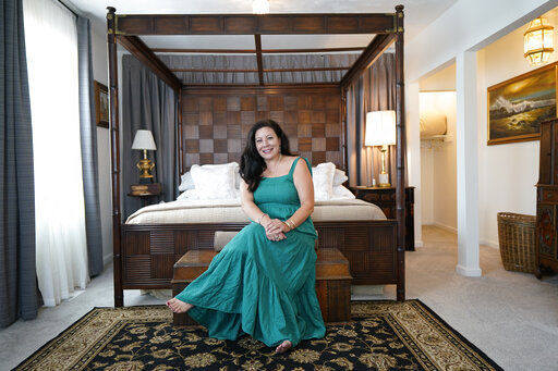 Heather Bise, owner of The House of Bise Bespoke, poses in the "Art" bedroom, Monday, July 19, 2021, in Cleveland. Small businesses in the U.S. that depend on tourism and vacationers say business is bouncing back, as people re-book postponed trips and take advantage of loosening restrictions, a positive sign for the businesses that have struggled for more than a year. Bise started in 2019 and catered to international tourists, attracting guests from New Zealand, Botswana, Eastern Europe and elsewhere. (AP Photo/Tony Dejak)    PHOTO CREDIT: Tony Dejak