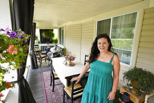 Heather Bise, owner of The House of Bise Bespoke, poses on the front porch where she entertains guests, Monday, July 19, 2021, in Cleveland. Small businesses in the U.S. that depend on tourism and vacationers say business is bouncing back, as people re-book postponed trips and take advantage of loosening restrictions, a positive sign for the businesses that have struggled for more than a year. Bise started in 2019 and catered to international tourists, attracting guests from New Zealand, Botswana, Eastern Europe and elsewhere. (AP Photo/Tony Dejak)    PHOTO CREDIT: Tony Dejak
