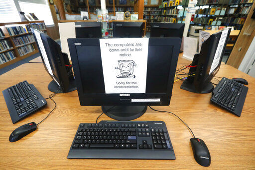 FILE - In this Aug. 22, 2019, file photo, signs on a bank of computers tell visitors that the machines are not working at the public library in Wilmer, Texas. The Associated Press has learned new details about a ransomware attack that affected roughly two dozen Texas communities two years ago. Thousands of pages obtained by AP and interviews with people involved show Texas communities struggled for days with disruptions to core government services as workers in small cities and towns endured a cascade of frustrations brought on by the sophisticated cyberattack. (AP Photo/Tony Gutierrez, File)    PHOTO CREDIT: Tony Gutierrez