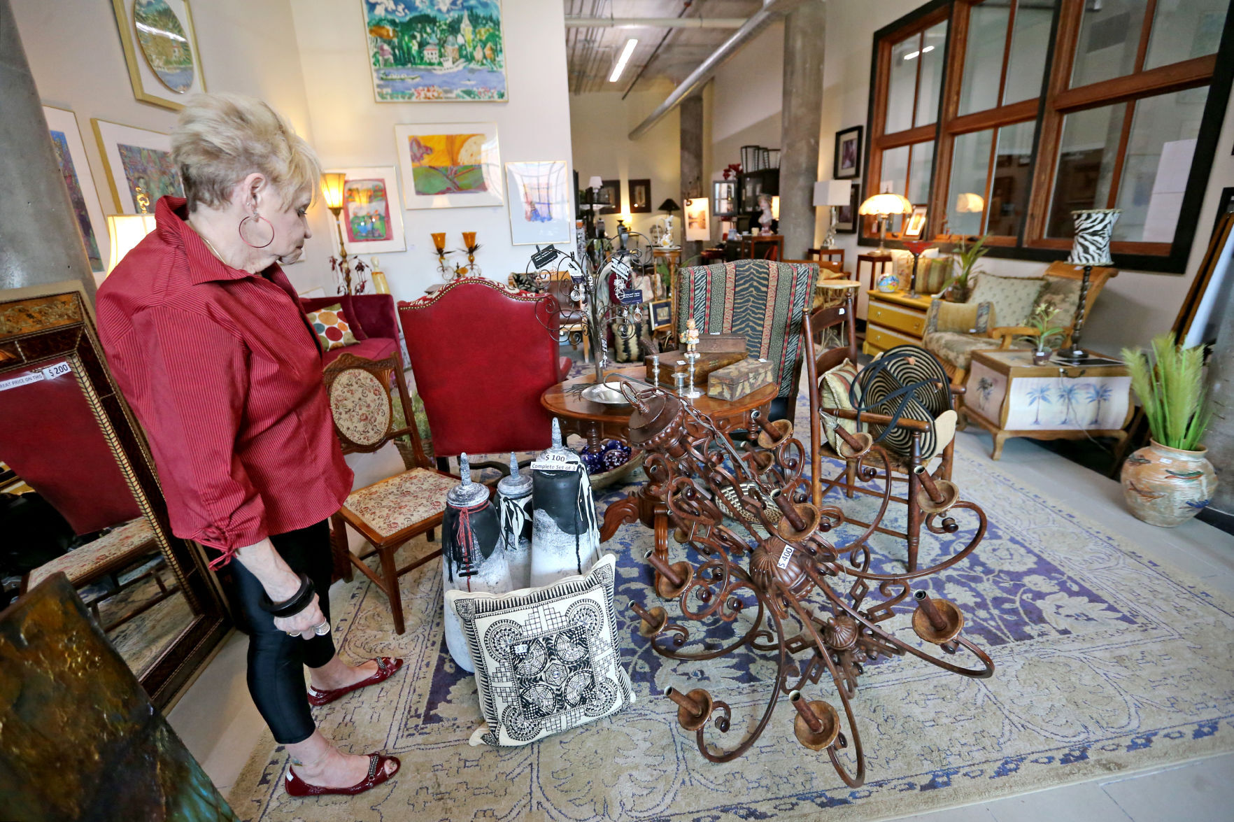 Carol Bush, of East Dubuque, Ill., browses items at The Consignment Store in the Novelty Iron Works building in Dubuque on Friday, July 23, 2021.    PHOTO CREDIT: JESSICA REILLY