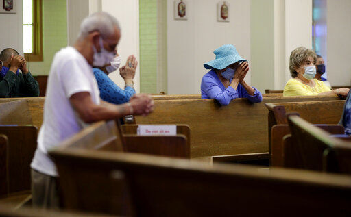 FILE - Parishioners wear face masks as they attend an in-person Mass at Christ the King Catholic Church in San Antonio, Tuesday, May 19, 2020. For the first time in nearly two decades, only half of U.S. households donated to a charity, according to a study released Tuesday, July 27, 2021. Experts say many factors are contributing to the decline. The percentage of Americans who give to religious causes has decreased in tandem with attendance at worship services as the number of Americans not affiliated with any religion grows. (AP Photo/Eric Gay, File)    PHOTO CREDIT: Eric Gay