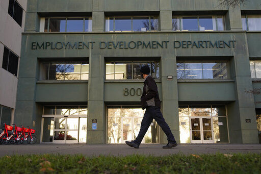 FILE - In this Dec. 18, 2020, file photo, a person passes the office of the California Employment Development Department in Sacramento, Calif. The recession that broke out with onset of the coronavirus pandemic officially ended in April 2021, making it the shortest downturn on record, according to the committee of economists that determines when recessions begin and end. (AP Photo/Rich Pedroncelli, File)    PHOTO CREDIT: Rich Pedroncelli