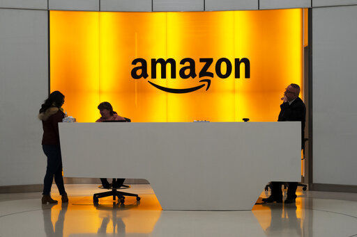 FILE - In this Feb. 14, 2019, file photo, people stand in the lobby for Amazon offices in New York. Amazon, which has been under pressure from shoppers, brands and lawmakers to crack down on counterfeits on its site, said Monday, May 10, 2021, that it blocked more than 10 billion suspected phony listings last year before any of their offerings could be sold. (AP Photo/Mark Lennihan, File)    PHOTO CREDIT: Mark Lennihan