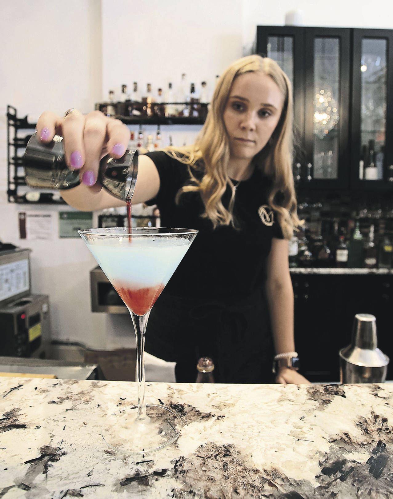 Bartender Lilly Streich pours a martini at Chanmpagne on Main in Galene, Ill., on Friday, July 16, 2021.    PHOTO CREDIT: SYSTEM
