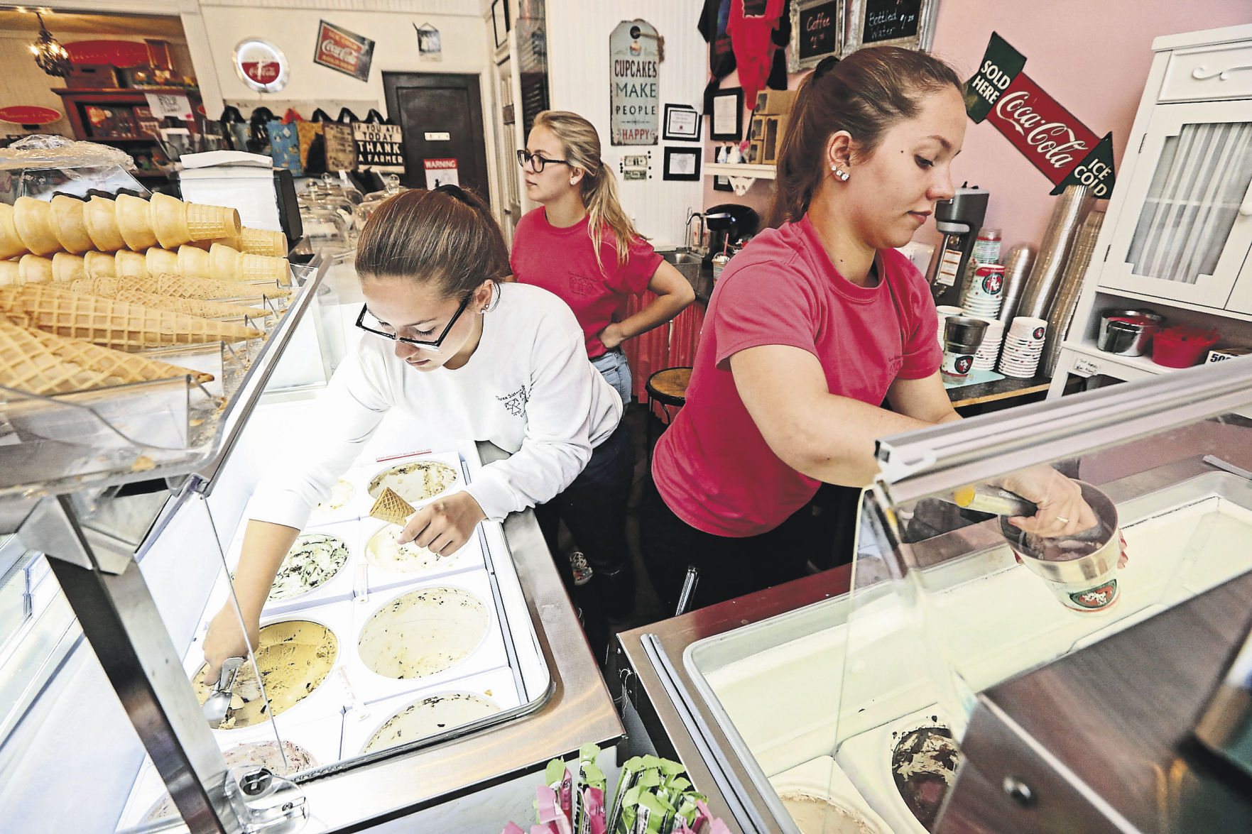 Sisters Evelyn (from left), Madelyn and Kate Walters prepare orders at Three Sisters Sweet Shoppe in Elizabeth, Ill.    PHOTO CREDIT: NICKI KOHL