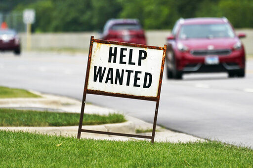 A help wanted sign is displayed at a gas station in Mount Prospect, Ill., Tuesday, July 27, 2021. The number of Americans applying for unemployment benefits fell last week by 14,000 to 385,000, Thursday, Aug. 5, more evidence that the economy and the job market are rebounding briskly from the coronavirus recession.(AP Photo/Nam Y. Huh)    PHOTO CREDIT: Nam Y. Huh