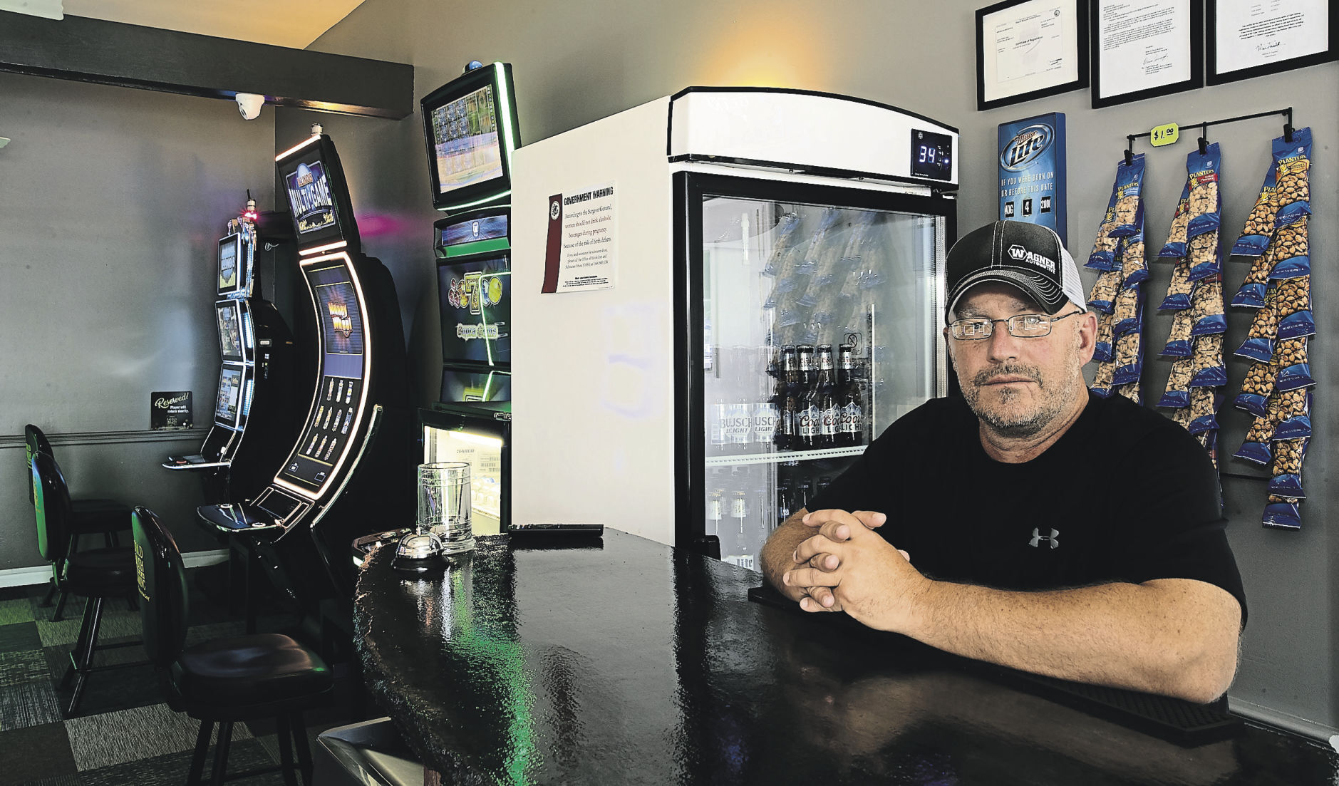 Paul Broshous sits behind the bar at Broshous Brewhous in Stockton, Ill. The gaming parlor opened on July 29.    PHOTO CREDIT: Stephen Gassman