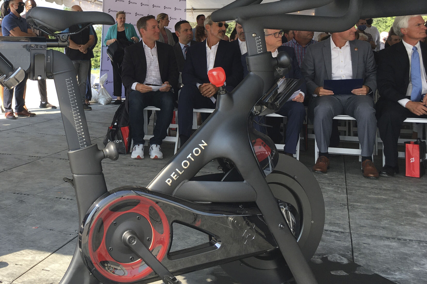 Peloton CEO John Foley (left) is seen behind one of his company