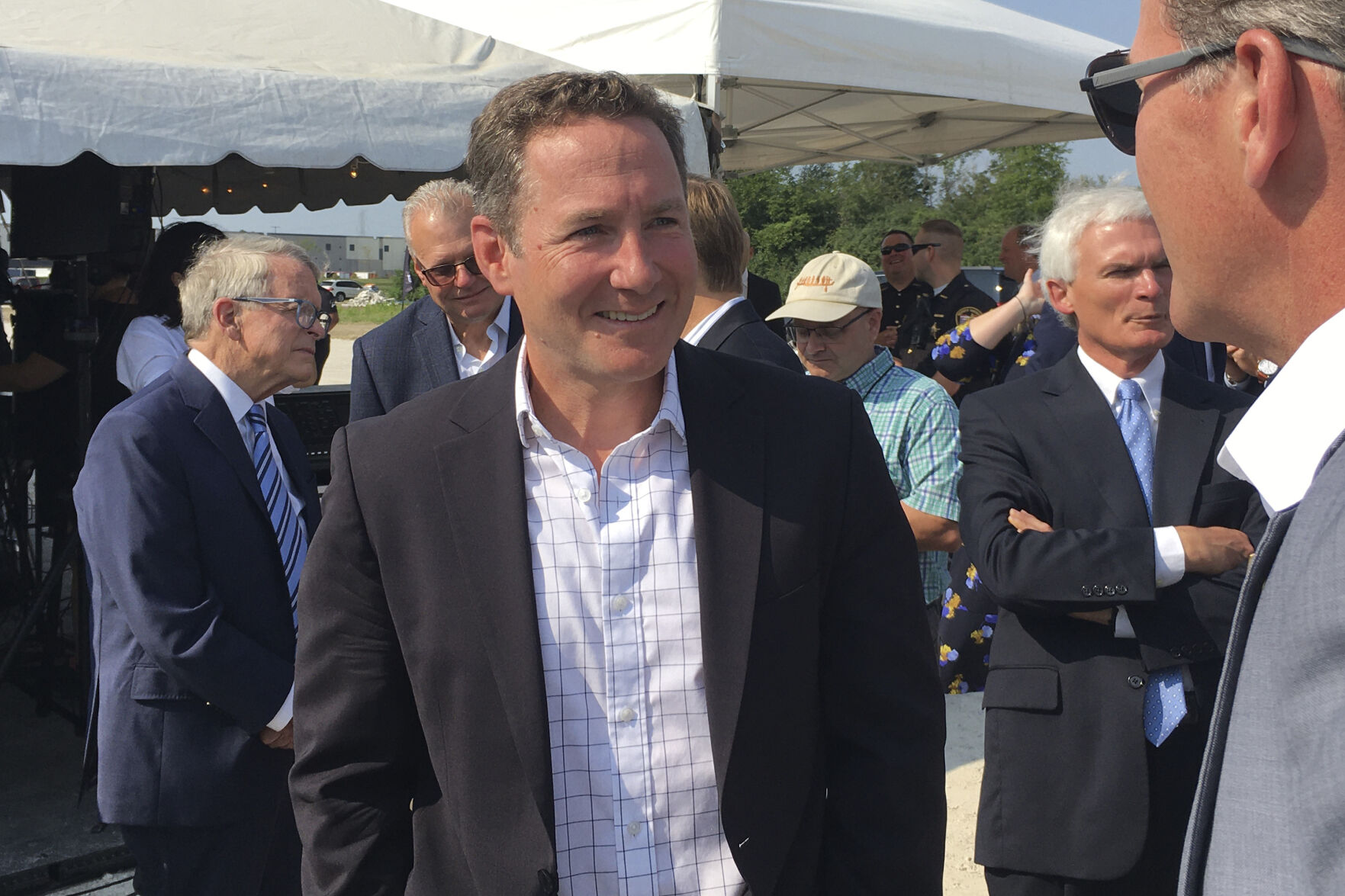 Peloton CEO John Foley speaks with Ohio Lt. Gov. Jon Husted before the groundbreaking for the company