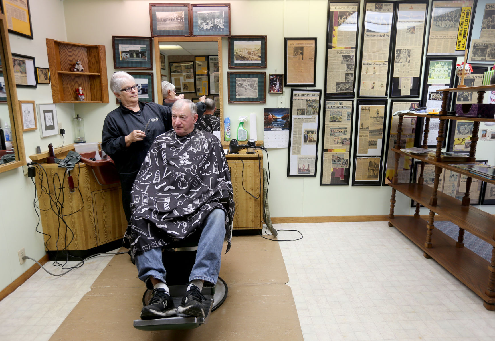 Joanie Von Glahn cuts hair for Glen Temperly, of Cuba City, Wis., at Joanie