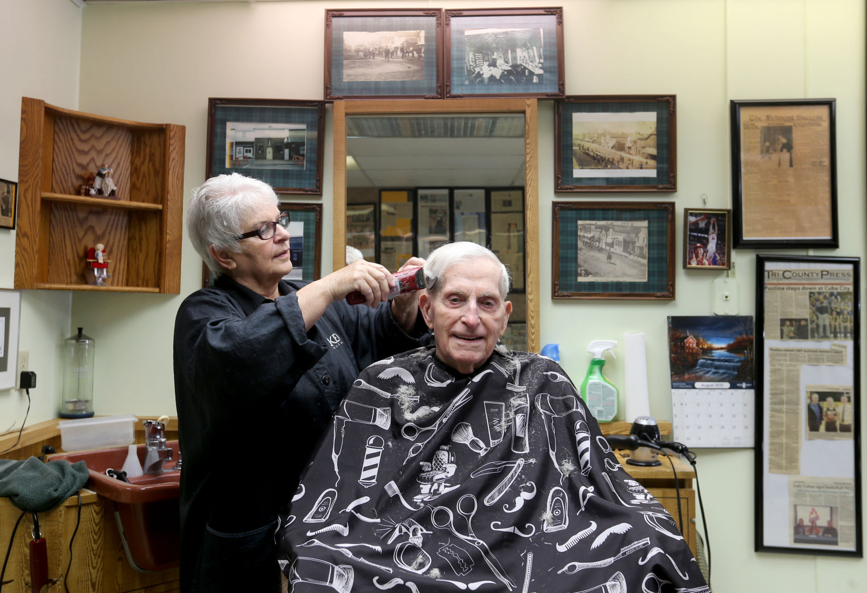 Joanie Von Glahn cuts hair for Merle Curtis, of Cuba City, Wis., at Joanie