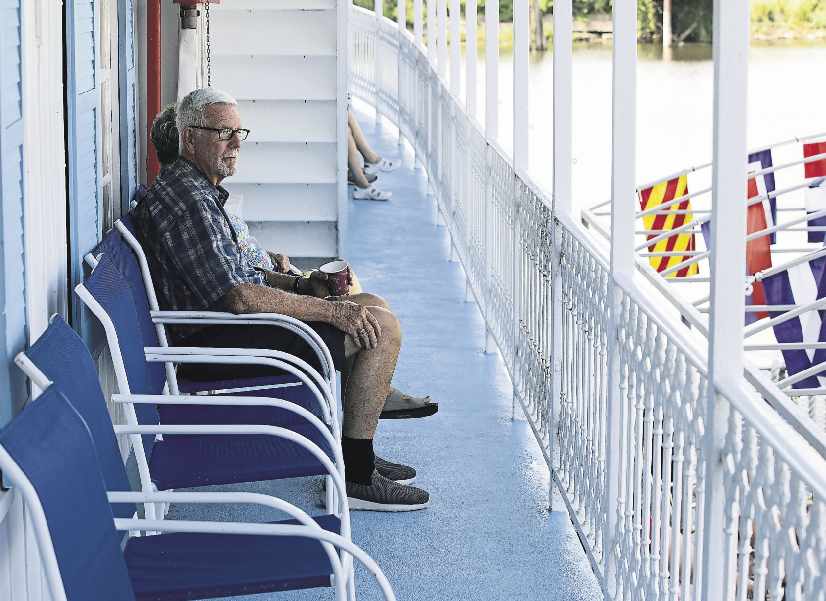 Dale Verhoeff, of Lincoln, Neb., relaxes on the deck as he waits for the Riverboat Twilight to depart the Port of Dubuque.    PHOTO CREDIT: Stephen Gassman