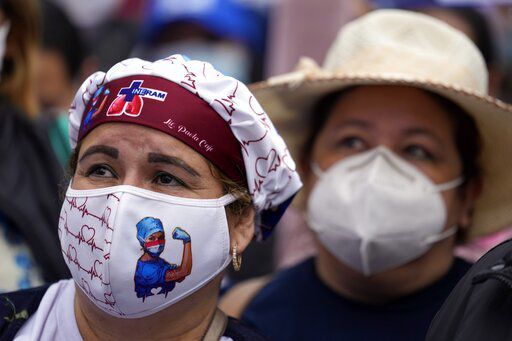 Nurse Paola Caje attends a march by public hospital nurses protesting for better salaries and the renewal of their temporary contracts amid the COVID-19 pandemic in Asuncion, Paraguay, Wednesday, Aug. 25, 2021. (AP Photo/Jorge Saenz)    PHOTO CREDIT: Jorge Saenz