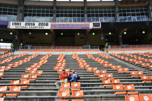 FILE - In this Oct. 31, 2020, file photo, Clemson fans arrive early before an NCAA college football game against Boston College in Clemson, S.C. Clemson, which has played in four of the past six national title games, estimated a university-wide loss of between $70 million and $135 million due to COVID-19 in the last fiscal year. About a third came from lost athletics revenue, and the vast majority of that came from reduced football ticket sales to ensure proper social distancing. ( Josh Morgan/Pool Photo via AP, File)    PHOTO CREDIT: Josh Morgan
