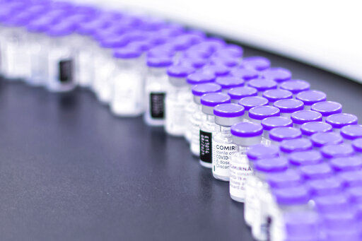 In this March 2021 photo provided by Pfizer, vials of the Pfizer-BioNTech COVID-19 vaccine are prepared for packaging at the company