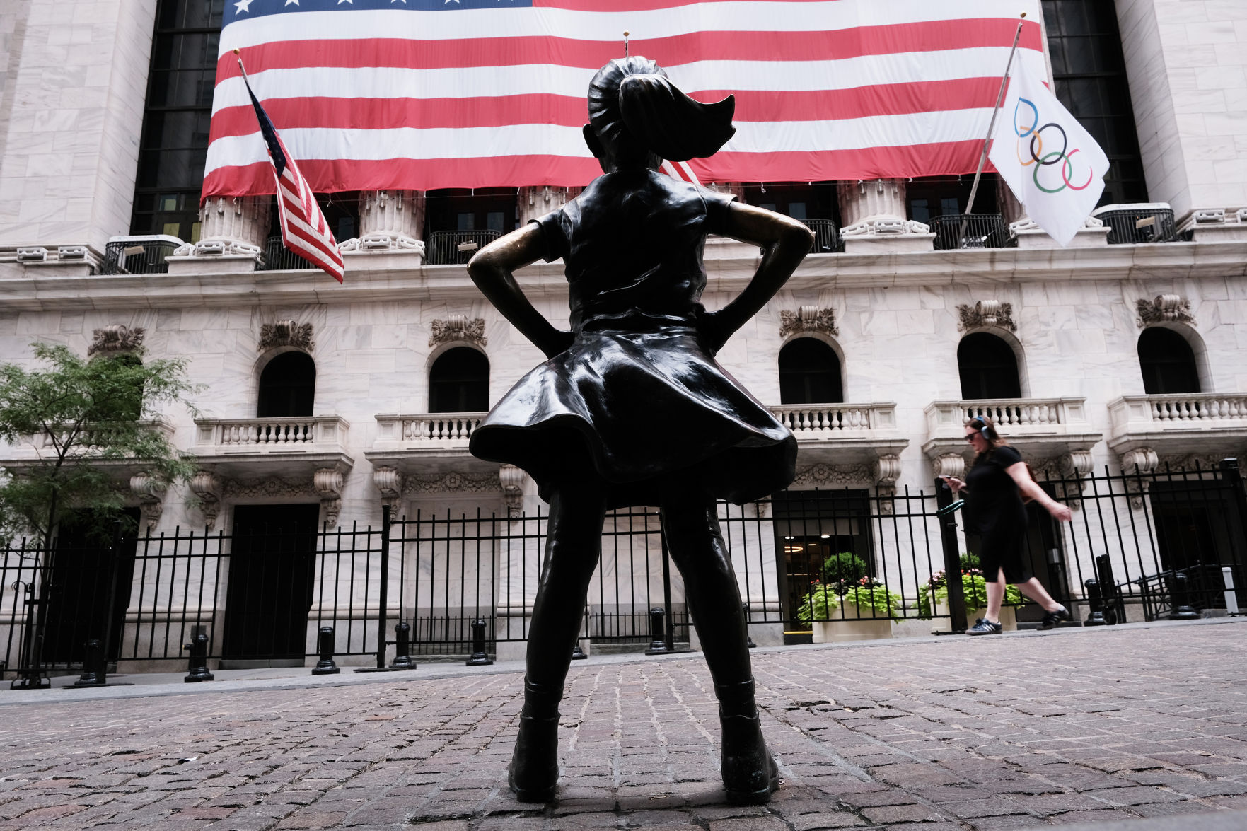 People walk by the Fearless Girl statue outside of the New York Stock Exchange in New York.    PHOTO CREDIT: Tribune News Service