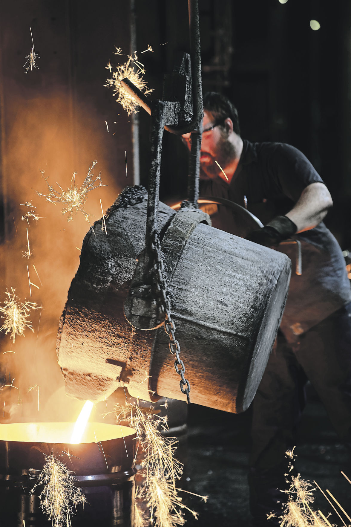 John Einsweiler pours molten iron from the bull ladle at the Lemfco foundry. Einsweiler owns the Galena, Ill., foundry with his sister, Desiree. It’s been at its 100 S. Commerce Street location since 1912. It has been under family ownership since it opened.    PHOTO CREDIT: Stephen Gassman